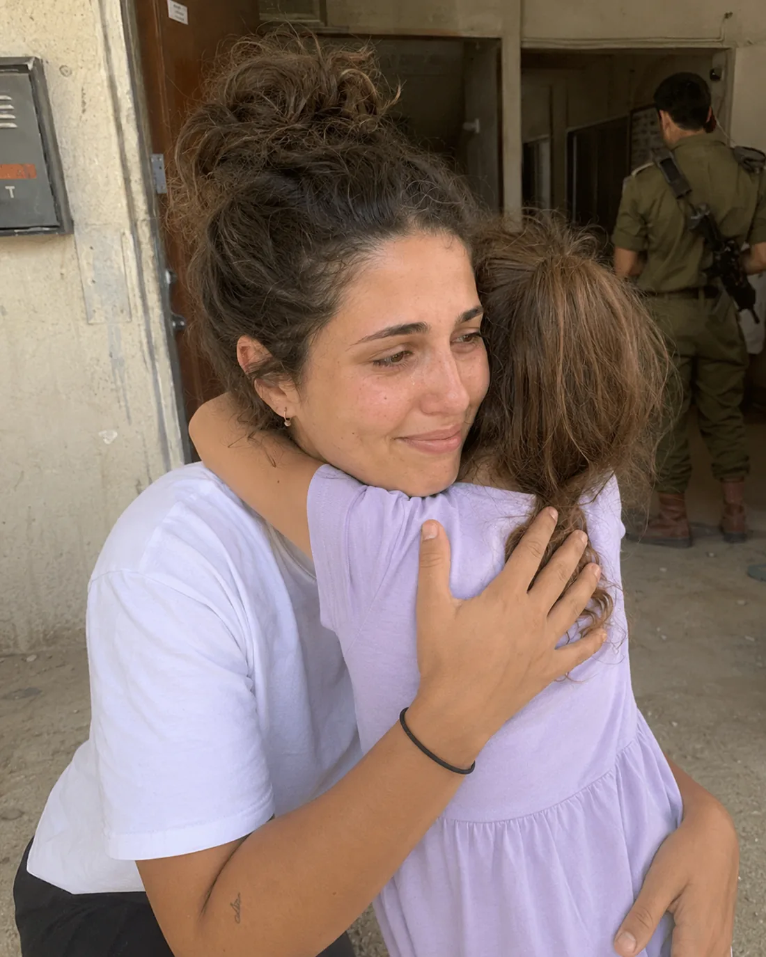 אם מחבקת את בתה בכניסה לבסיס